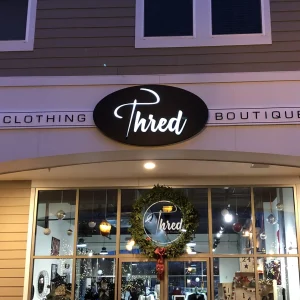 A illuminated sign box for a clothing store.